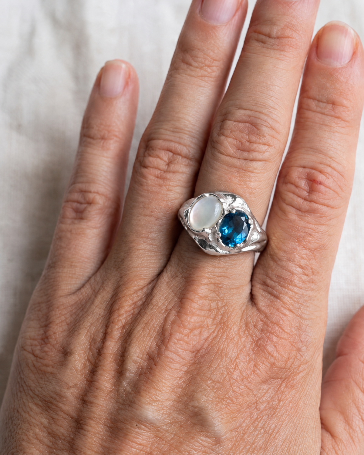 London Blue Topaz and Mother of Pearl Ring in 925 sterling silver worn on the hand, shown true to size