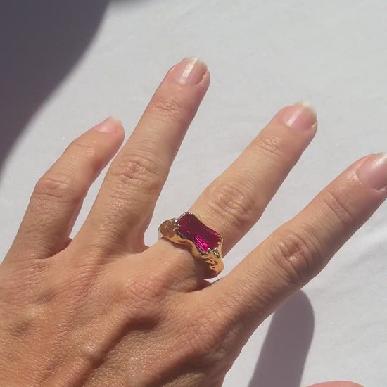 Wave Bar Ring in pink tourmaline worn on the hand in sunlight