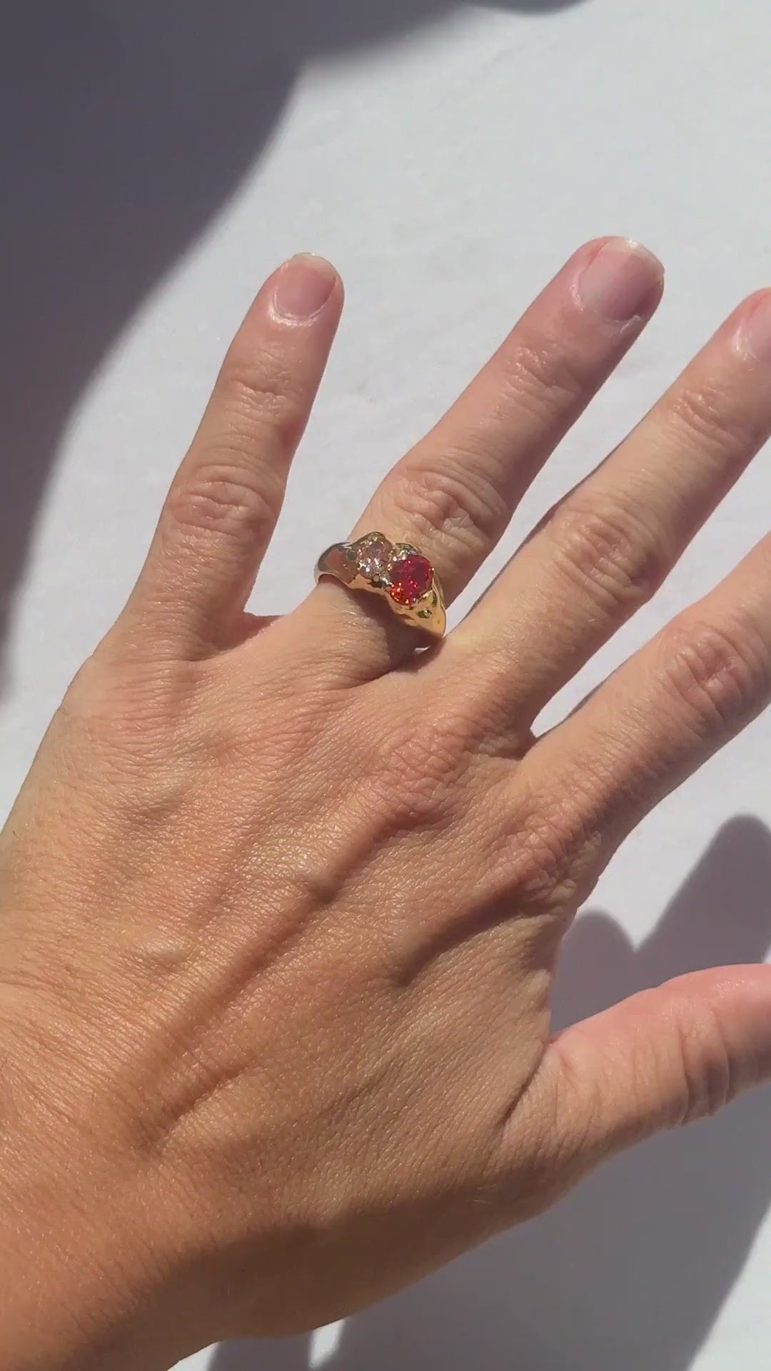 Ember Double Stone Ring in orange and peach worn on the hand in sunlight